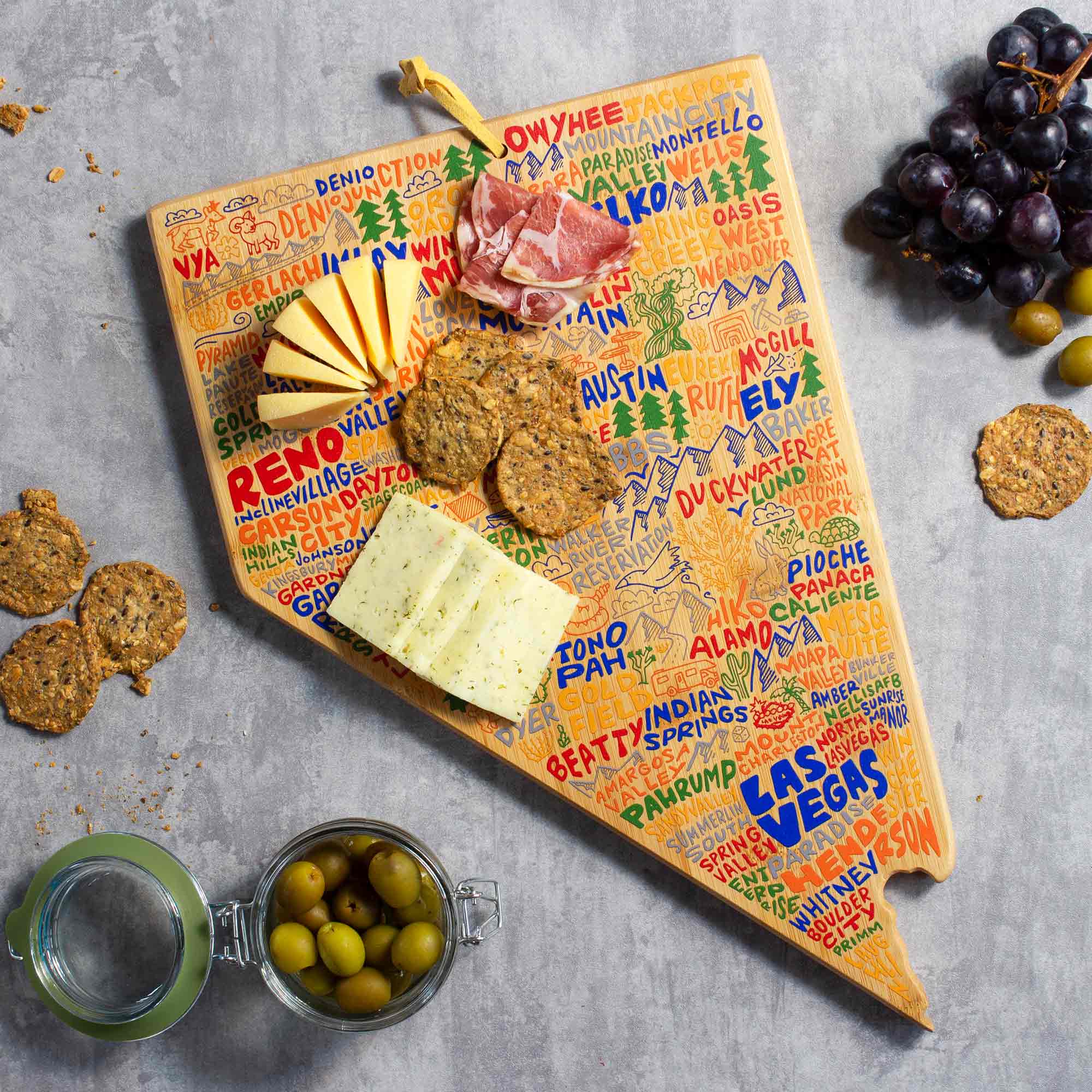 totally-bamboo-nevada-state-shaped-cutting-board-with-wander-on-words-artwork image 2